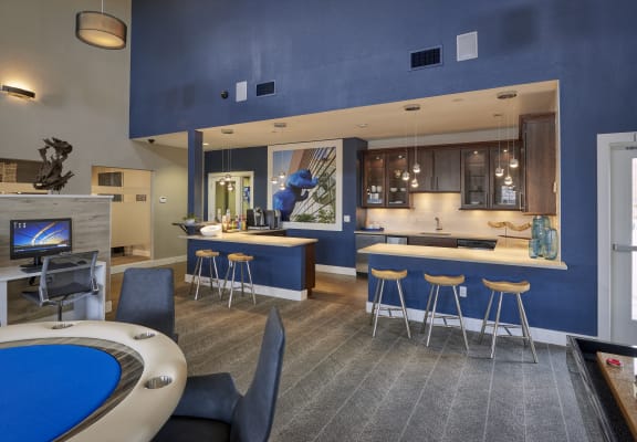 a clubhouse with a pool table and a bar and a kitchen