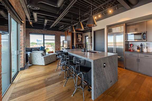 a kitchen with a large island and bar stools