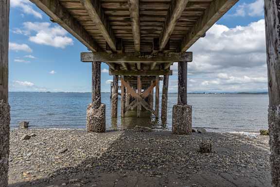 A wooden pier extends into a body of water.