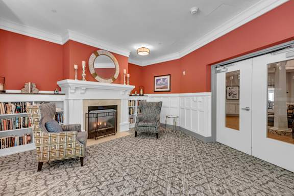 A living room with a fireplace and a chair.