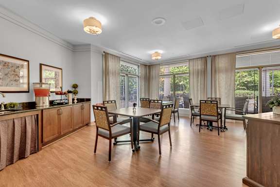 A dining room with a table set for six.