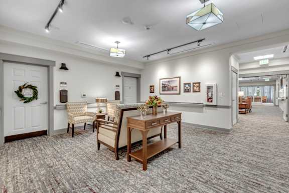 A room with a table and chairs in the center.