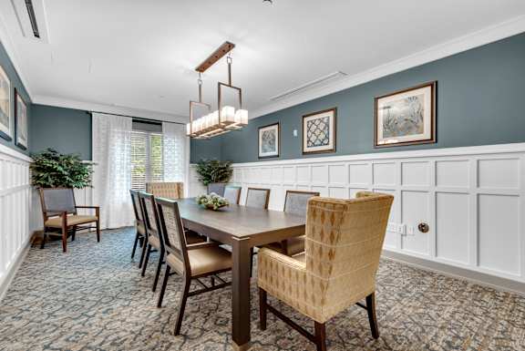 A dining room with a table set for four.
