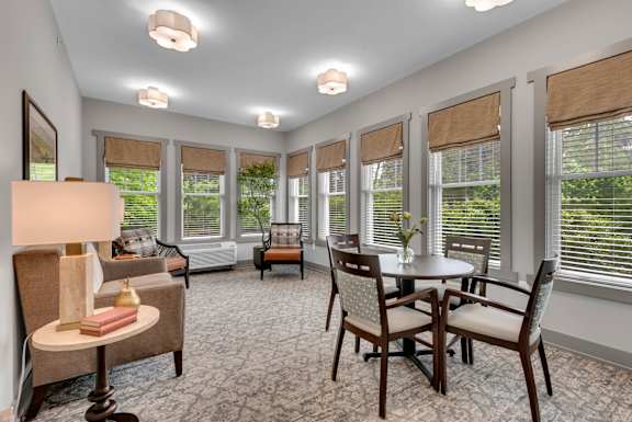 A well-lit room with a table and chairs.