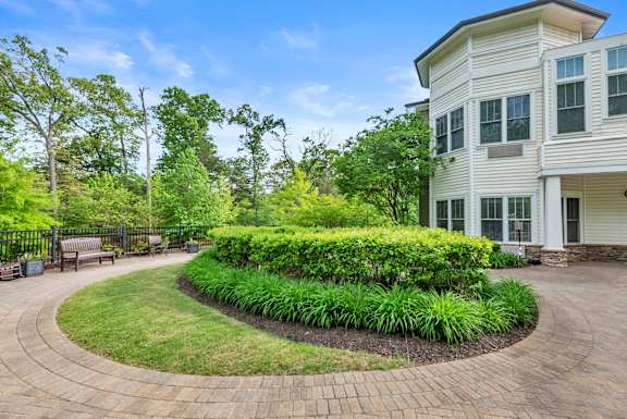 A white house with a landscaped front yard.