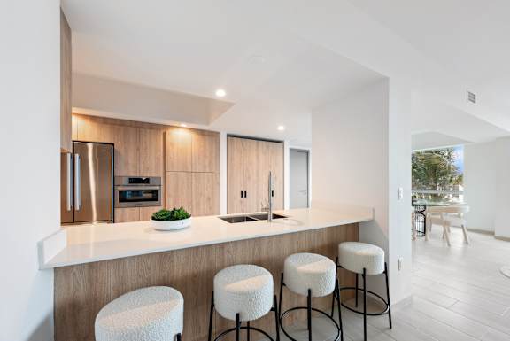 A modern kitchen with a bar stool.