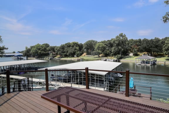 a deck with a view of a lake and a dock at The Legends at Eagle Mountain Lake, Texas, 76179