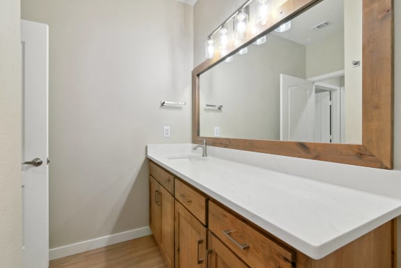 an empty bathroom with a sink and a mirror at The Canyons Apartments, Fort Worth, TX