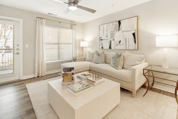 a white bedroom with a large bed and a ceiling fan at The Azul Apartment Homes, Oxford, Mississippi, 38655
