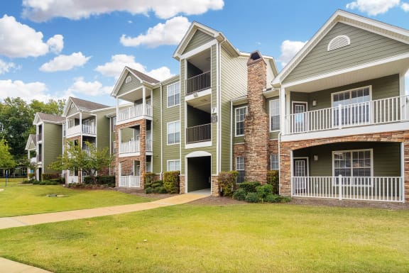 a bedroom with a bed and a ceiling fan  at Quail Ridge Highlands Apartment Homes, Bartlett, Tennessee