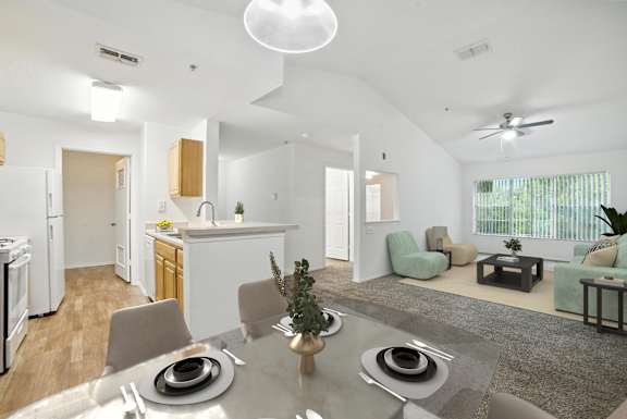 A modern kitchen with a dining table set for two.