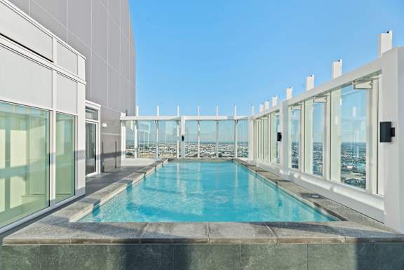 A swimming pool on a balcony with a view of the city. at Olympic + Hill Apartments, Apartments, Los Angeles, CA