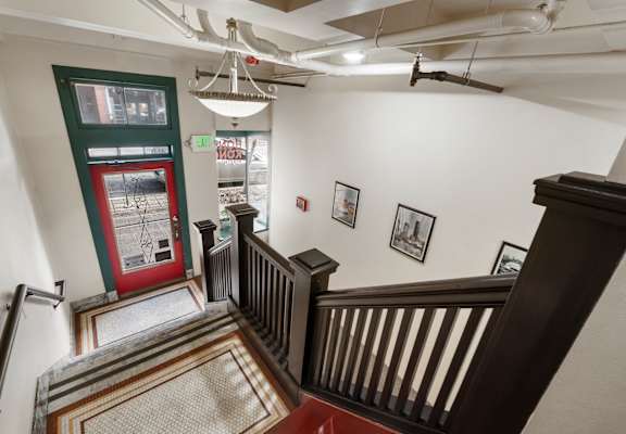 A staircase with a chandelier hanging from the ceiling.