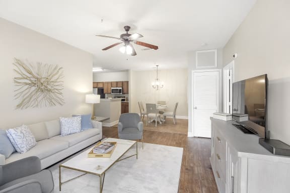 a rendering of a living room with a kitchen in the background  at Quail Ridge Highlands Apartment Homes, Bartlett, TN, 38135