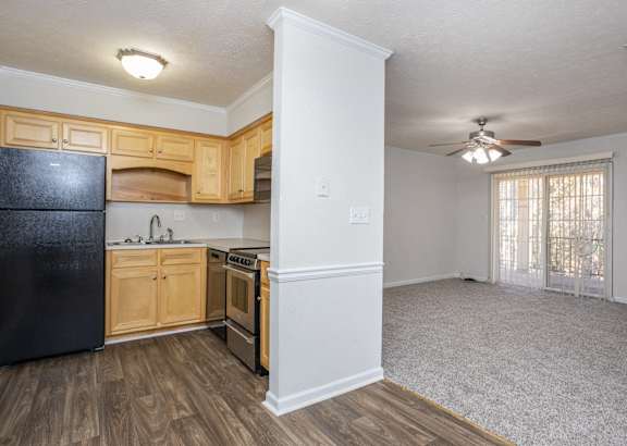 a living room filled with furniture and a ceiling fan