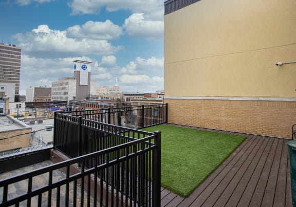 a small astroturf lawn on the rooftop of a building