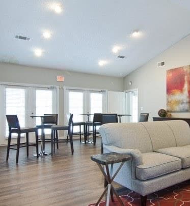 a living room with a couch a table and chairs