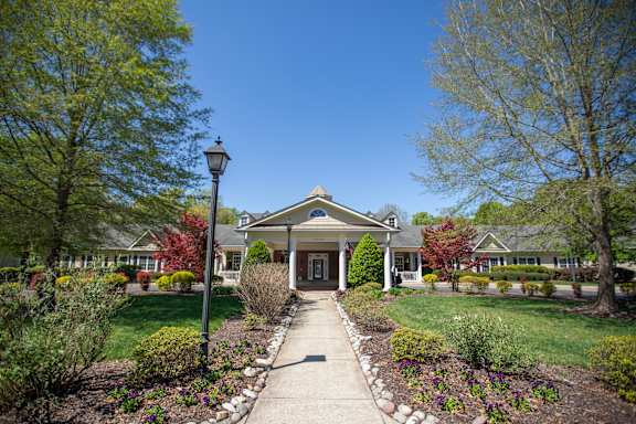 A house with a front yard and a lamp post.