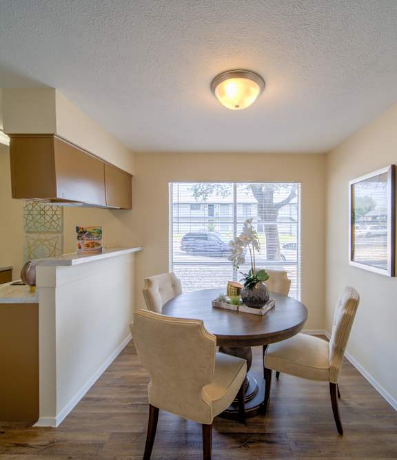 a living room with a couch and a chair and a rug at Villas del Tesoro Apartments, Dallas, TX, 75228