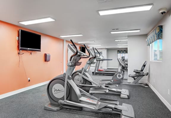 the gym has plenty of cardio equipment and a flat screen tv at Desert Bay Apartments, Laughlin, Nevada, 89029