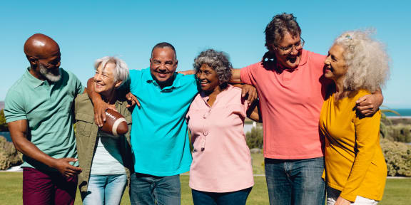 a group of people embracing each other on a field