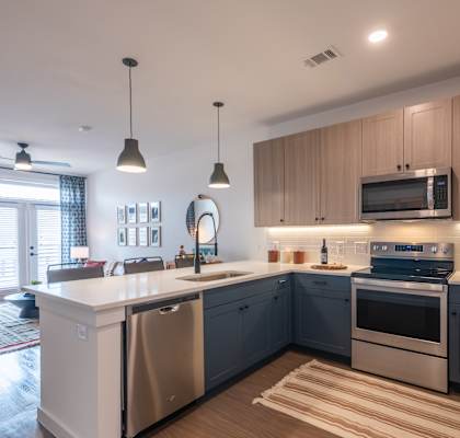 a kitchen with a large island and stainless steel appliances