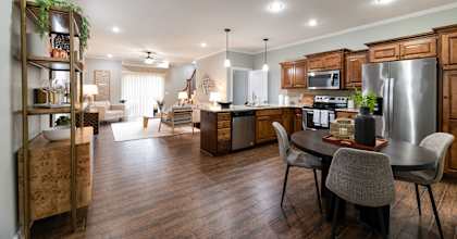 A modern kitchen with a dining table and chairs.
