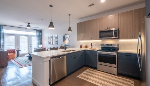 a kitchen with a large island and stainless steel appliances