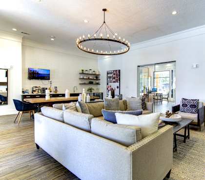A modern living room with a large sectional sofa and a coffee table.