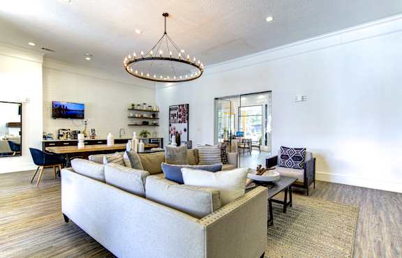 A modern living room with a large sectional sofa and a coffee table.