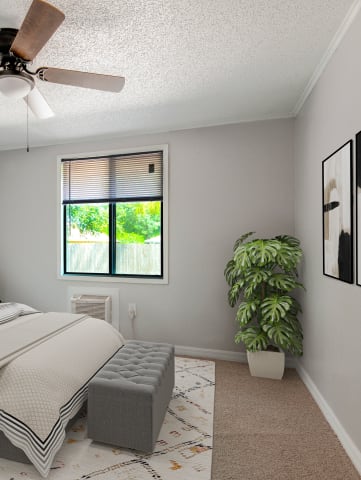 a furnished apartment bedroom at Mount Dora Apartments