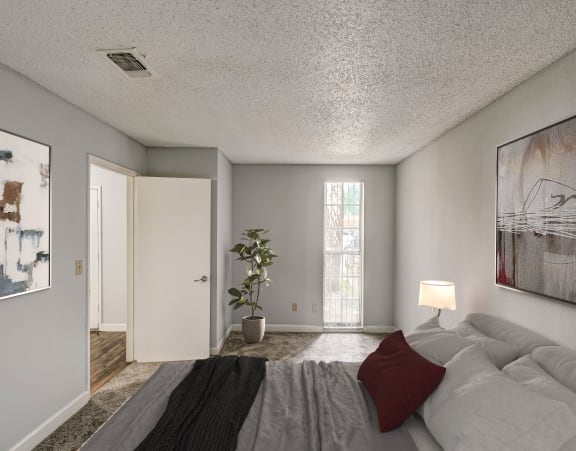 a bedroom with a bed and a painting on the wall
