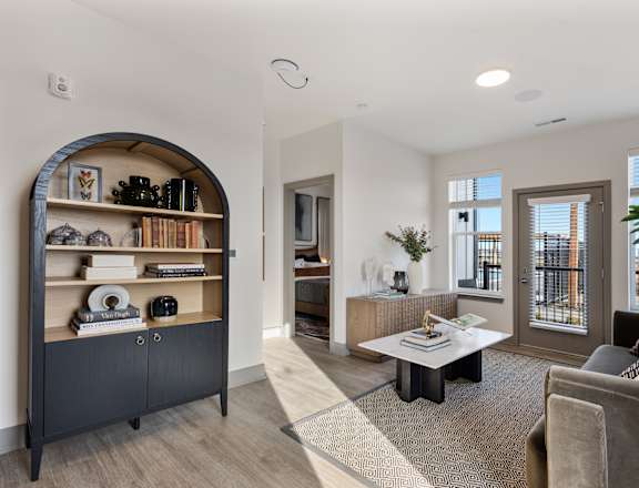 A living room with a grey couch and a coffee table.