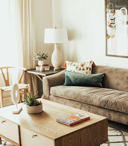 a living room with a brown couch and a coffee table
