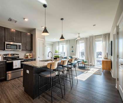 A modern kitchen with dark wood cabinets and a central island.