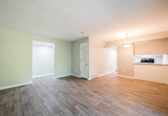 A room with a wooden floor and a window.