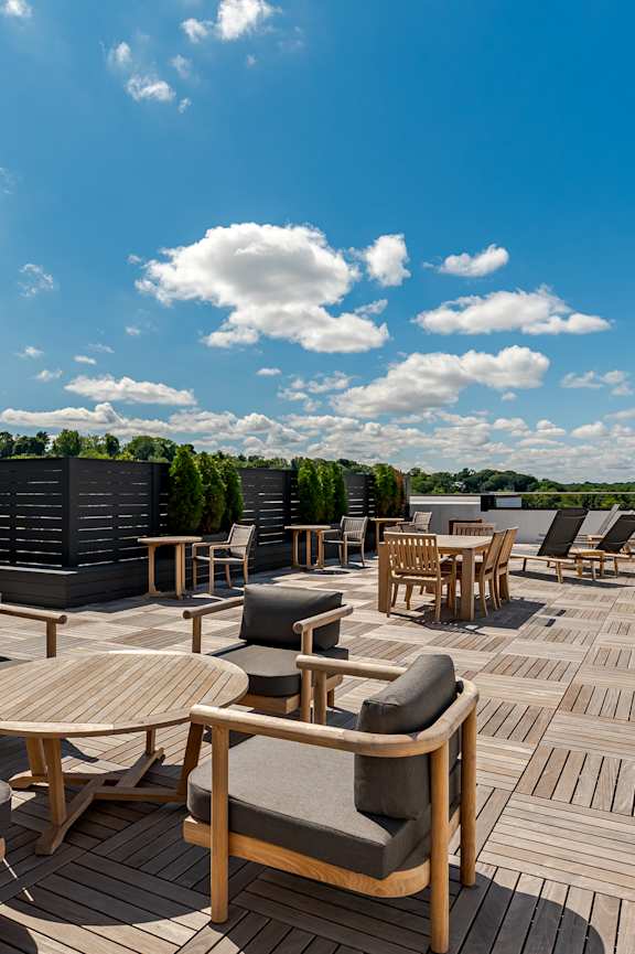 A group of people are sitting on a patio enjoying drinks.