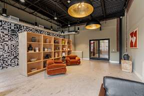 A room with a black ceiling and a white wall with a red logo on it.
