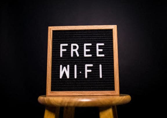 a free wifi sign on a wooden stool