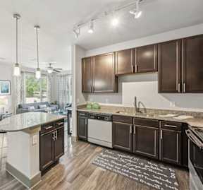 A modern kitchen with dark brown cabinets and a white island.