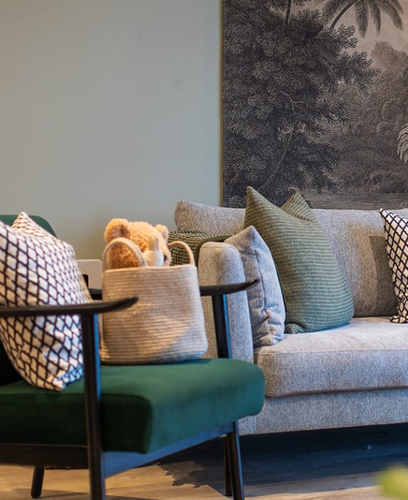 a couch with pillows and a plant in a living room