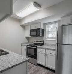 a kitchen with granite counter tops and stainless steel appliances