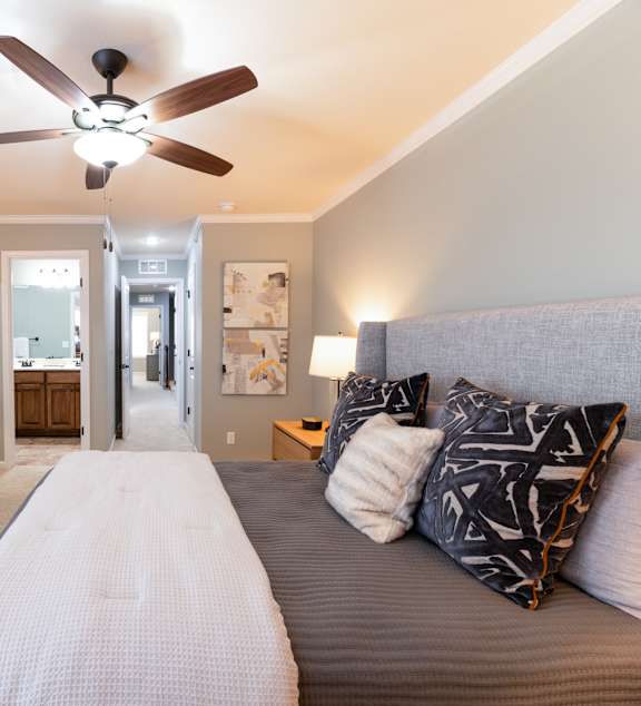 a bedroom with a large bed and a window  at Prairie Pines Townhomes, Kansas
