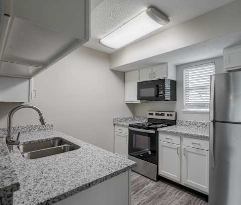 a kitchen with granite counter tops and stainless steel appliances