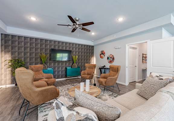 a living room with a couch and chairs