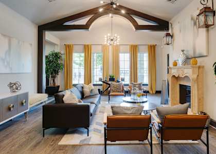 A living room with a fireplace and a large window.
