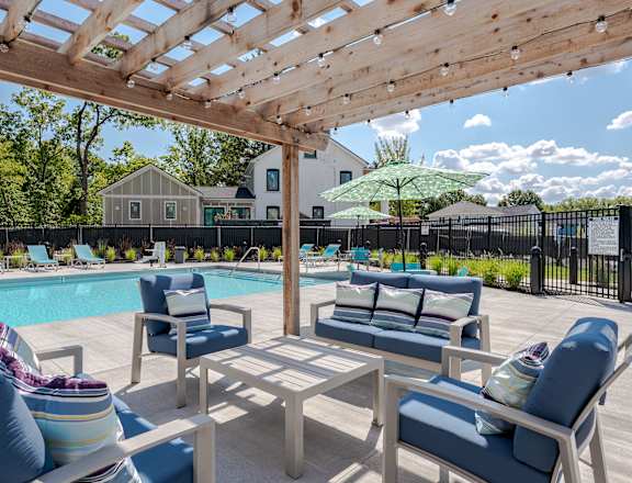 our apartments have a resort style pool with lounge chairs and a pergola