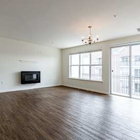 A room with a wooden floor and a chandelier.