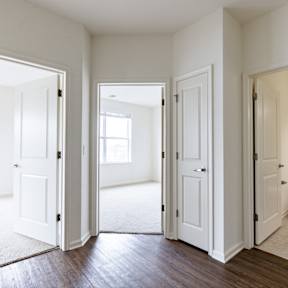 A white bathroom with a toilet and a window.