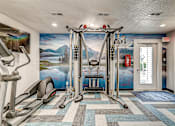 Thumbnail 4 of 28 - A gym with a treadmill, elliptical trainer, and other exercise equipment.